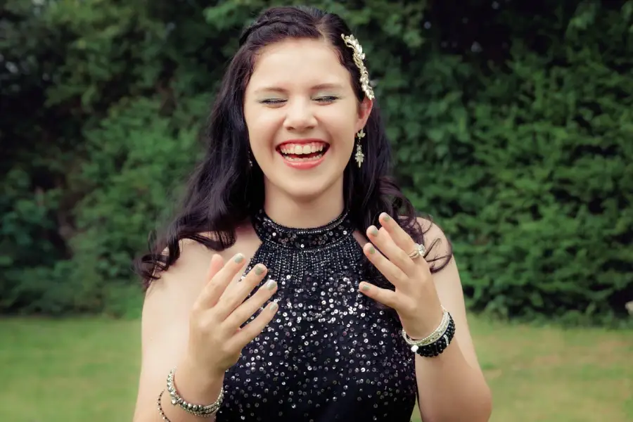 laughing teenage girl black dress outside
