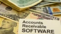 A stack of US dollar bills with a prominent paper label reading “Accounts Receivable SOFTWARE,” representing financial management and cash flow.