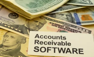 A stack of US dollar bills with a prominent paper label reading “Accounts Receivable SOFTWARE,” representing financial management and cash flow.